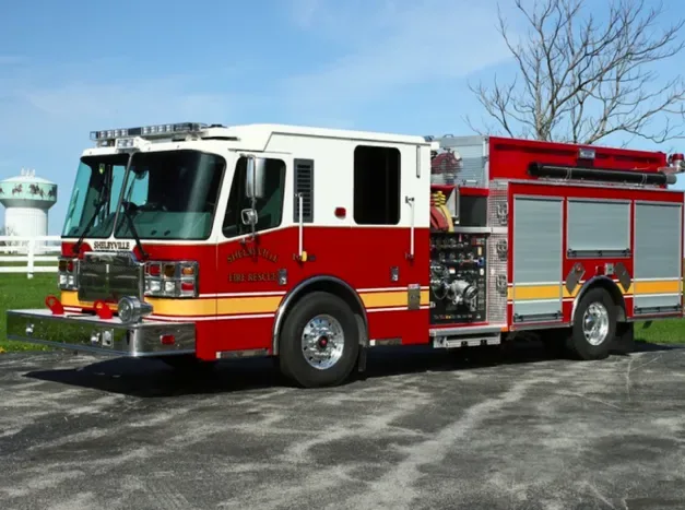 2015 Ferrara cinder fire truck in red and white parked in firehouse yard